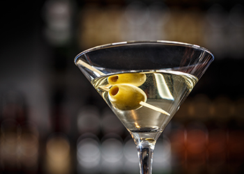 Martini cocktail with green olives Martini cocktail with green olives