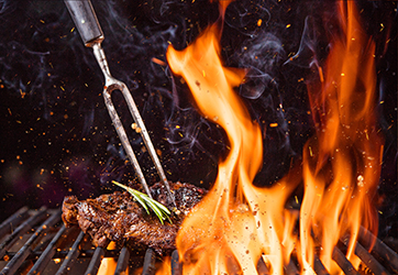 Beef steak on the grill with flames Beef steak on the grill with flames