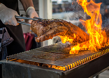 Grilling entrecote on a barbecue with fire Grilling entrecote on a barbecue with fire
