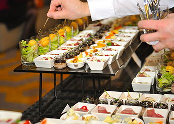 Catering stuff arranging finger food Catering stuff arranging finger food