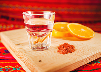 Mezcal shot with orange slices and worm salt in oaxaca mexico Mezcal shot with orange slices and worm salt in oaxaca mexico