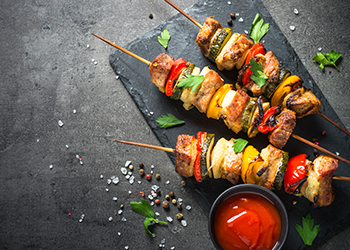 Grilled shish kebab with vegetables on black. Grilled shish kebab with vegetables on black.