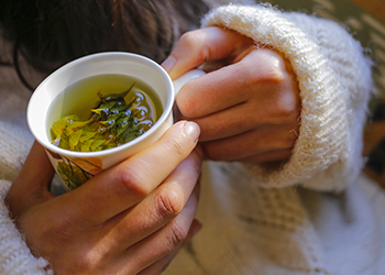 Sage tea with woman hand Sage tea with woman hand