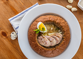 Traditional polish zurek with sausage, egg in bread