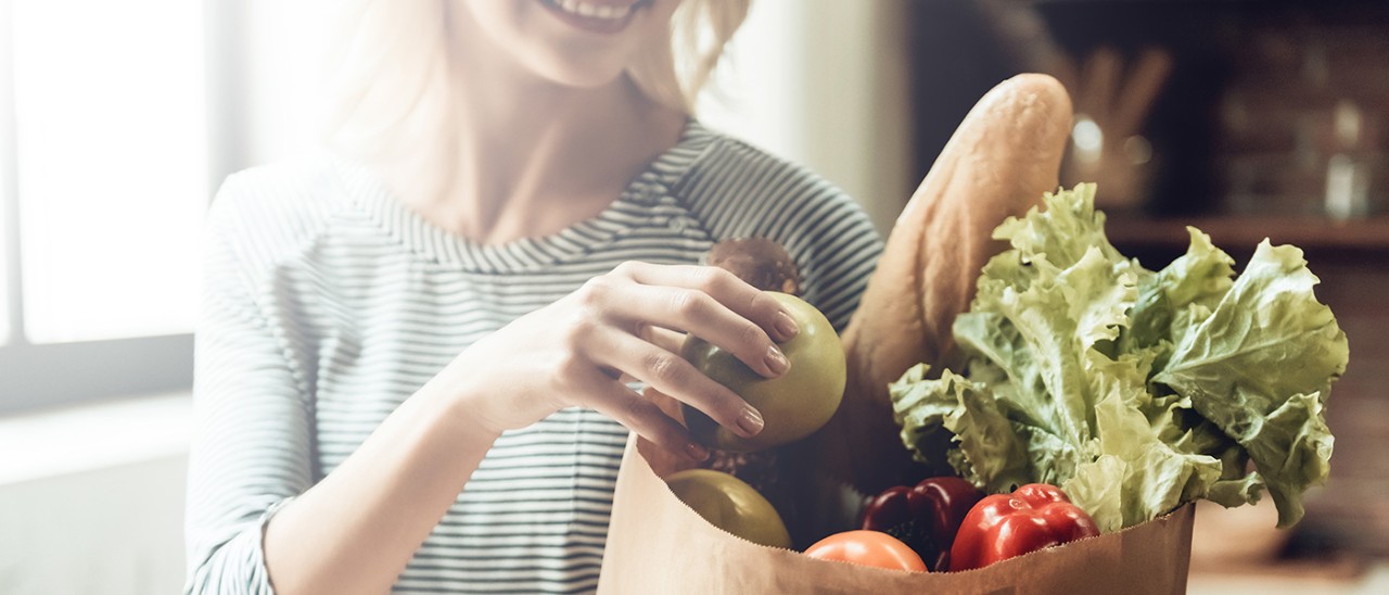 6082030 Closeup of Smiling Girl holds Bag of Healthy Food